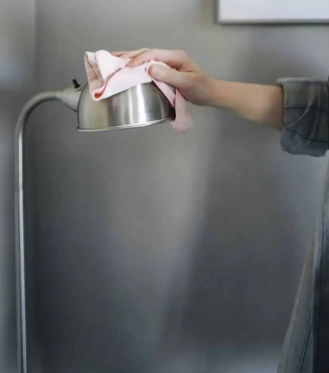 wiping the fixture with a microfiber cloth | CleanHelp Canada Image about how to clean light fixtures